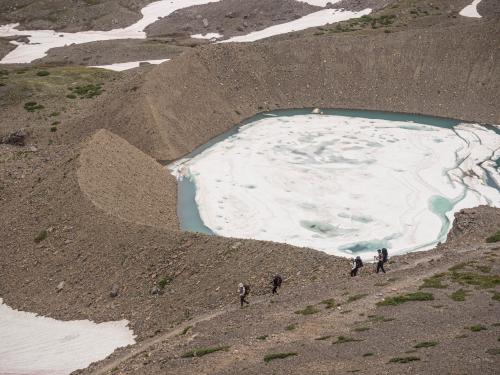 Moraine in the background, and a group of hiker in the foreground