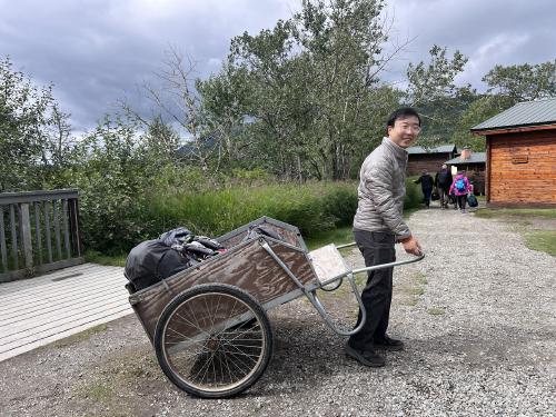 author using a cart to move gear