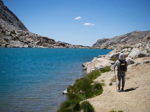 Hiker walking along a lakeshore